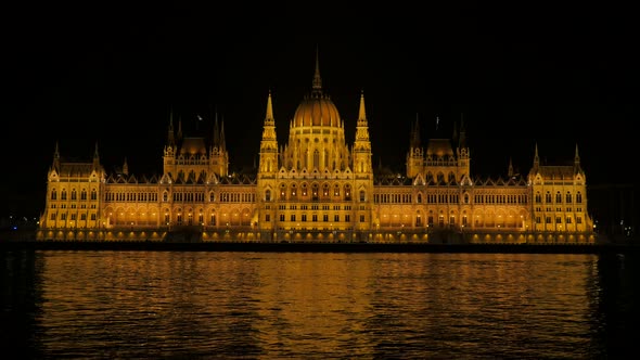 National Parliament building in Budapest and river Danube by the night 4K 2160p UltraHD footage - Ri