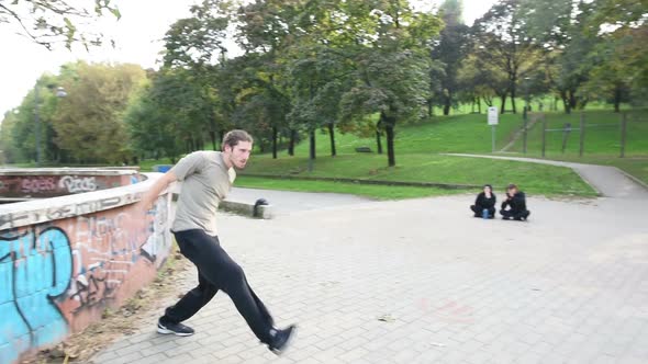 Young beautiful caucasian man doing parkour outdoor