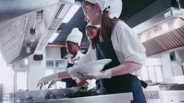 Group of schoolgirls having fun learning to cook. Female students in a cooking class.