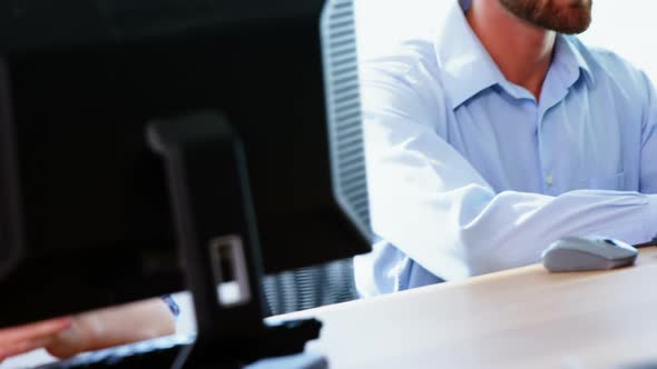 Male executive with headset working on computer