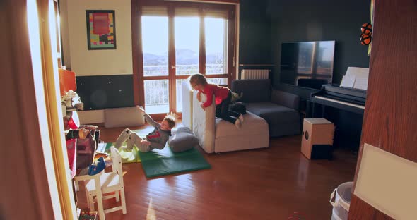 Two Children Playing Together at Home. Brother and Sister Play Indoors. Side View Long Shot. Kids