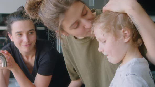 LGBTQ Family Doing Dishes Together at Home