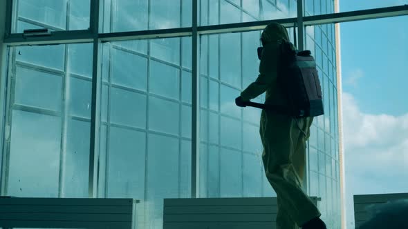 Massive Window is Getting Sanitized By a Worker in a Splash Suit