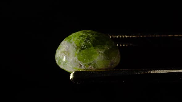 Natural Hydrogrossular Green Garnet in Tweezer on Turn Table