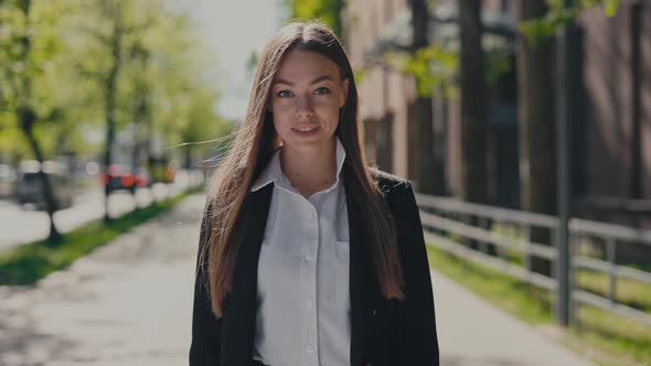 Portrait of Positive Brunette Woman Outside Business Center