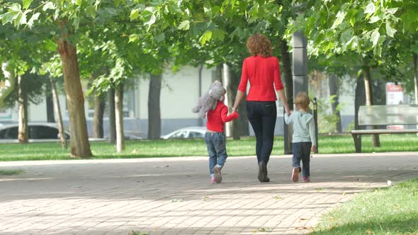 Family on a Walk in Summer. Child with Mother Together