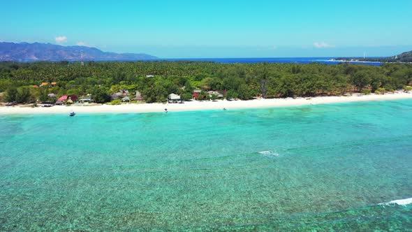 Aerial scenery of tranquil resort beach lifestyle by blue sea and bright sandy background of a dayou