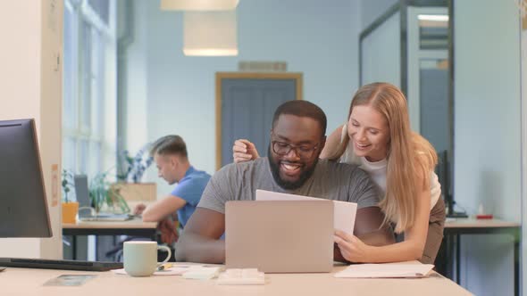 Business Woman Explaining Project To Colleague