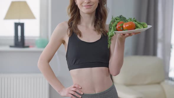 Unrecognizable Confident Slim Woman Holding Plate with Healthful Organic Vegetables Smiling