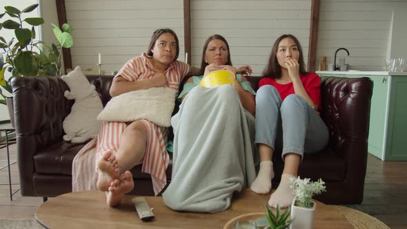 Group of Multicultural Women Watching Thriller on Digital TV at Home