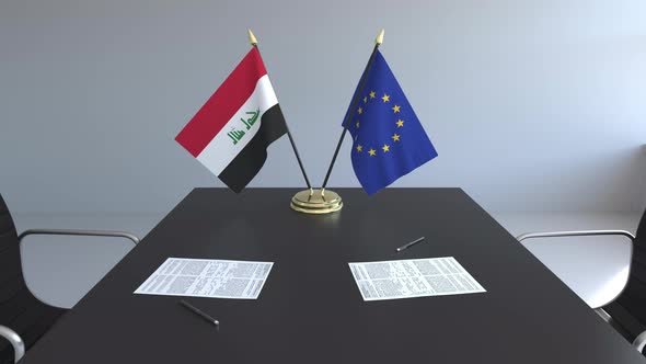 Flags of Iraq and the European Union on the Table