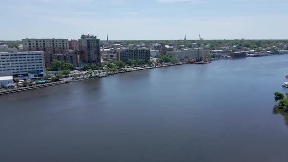 Wide drone shot of downtown Wilmington North Carolina and Cape Fear River