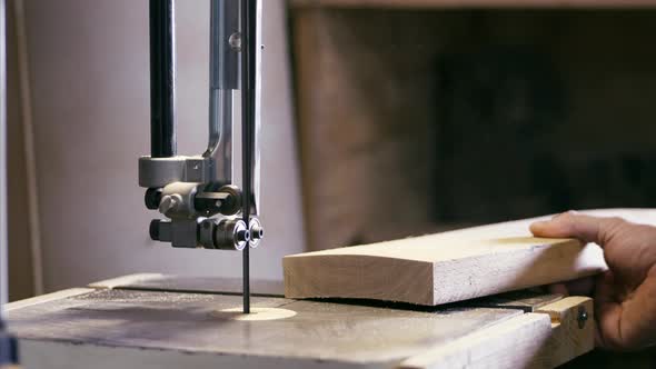 Closeup Hands of Male Carpenter Working on Milling Machine with Wood Detail