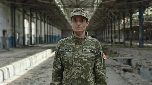 American Female Soldier Standing Among Ruinations