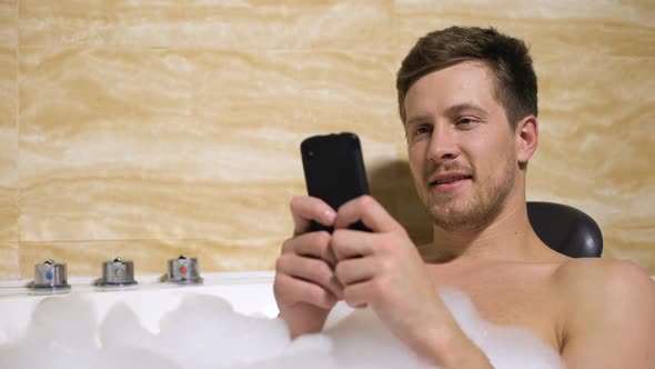 Clumsy Man Accidentally Dropping Phone Into Water Taking Bath With Foam, Fail