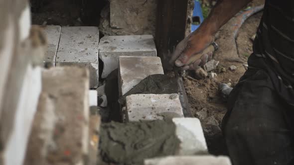 Construction Worker or Mason Laying Bricks and Creating Walls. Bricklayer Laying Bricks To Make a