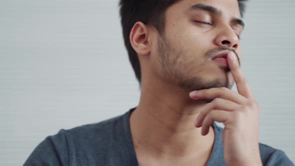 Handsome Indian man wearing t-shirt working