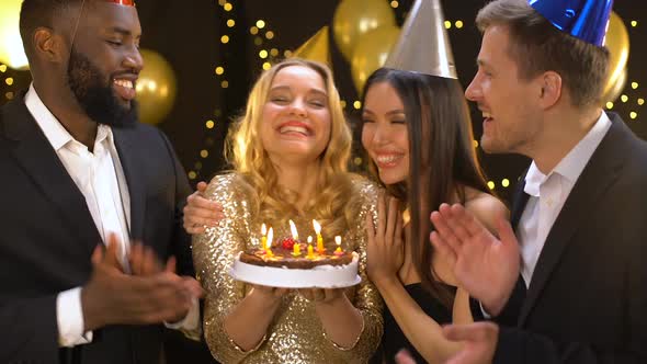 Happy Blond Female Blowing Cake Candles, Friends Congratulating Woman Birthday