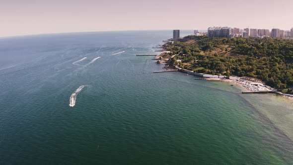 Aerial Shot of a Sea Coast Line During Summer Sunny Day Boats are Passing By