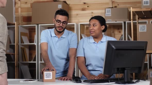 Postal Workers Accepting and Registering Parcel for Shipping