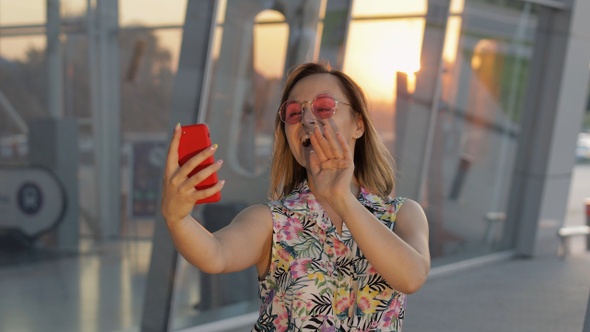 Tourist Girl Wearing Trendy Sunglasses Uses Phone. Using Smartphone for Call, Talk. Trip, Tourism