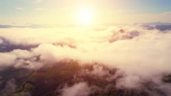 Drone flying above the clouds during sunrise