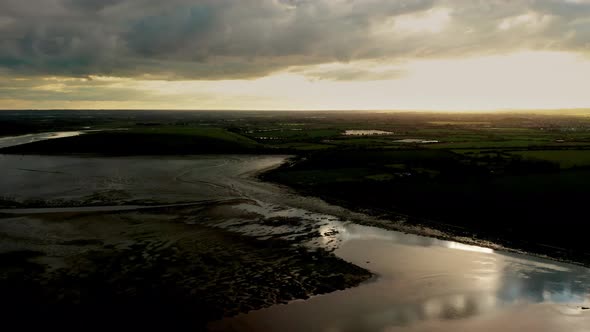 Drone tracking right over textured Irish landscape