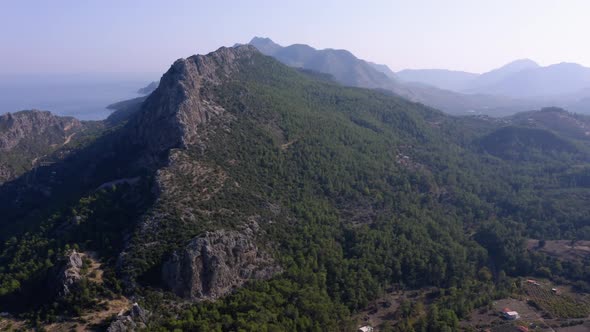 Aerial Drone View of High Mountains Covered with Green Forests