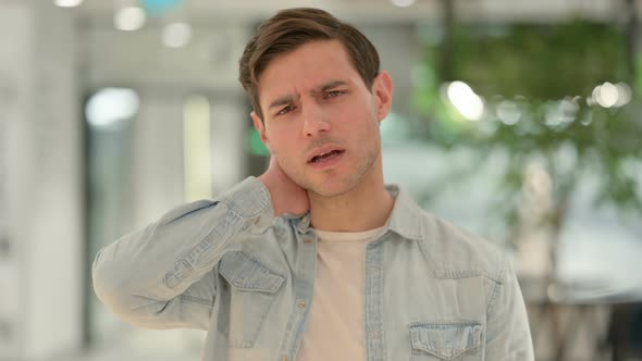 Portrait of Creative Young Man Having Neck Pain