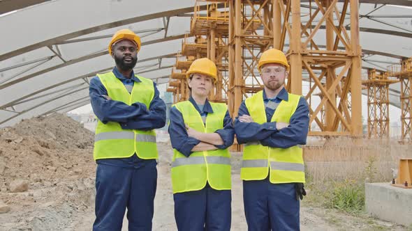 Portrait of Construction Workers by Unfinished Building