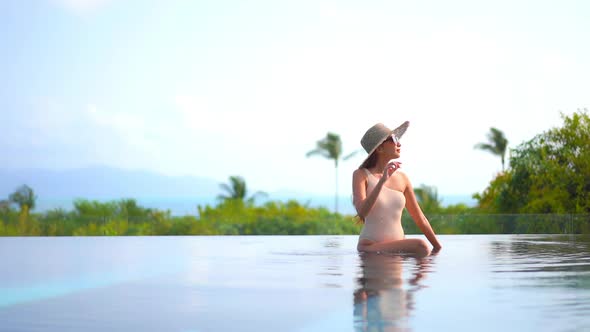 Young asian woman enjoy around outdoor swimming pool for leisure