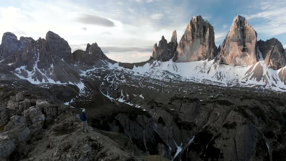 Aerial Man Hiker In Front of Tre Cime di Lavaredo Mountain in Dolomites Italy