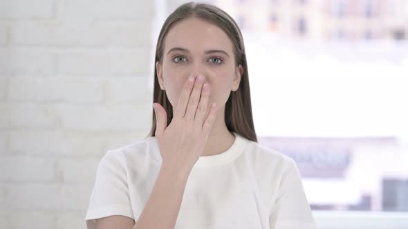 Portrait of Beautiful Young Woman Giving Flying Kiss