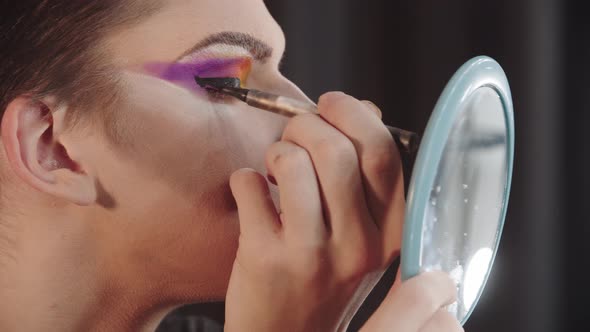 Drag Artist  Young Man Applying a Thick Black Eyeliner