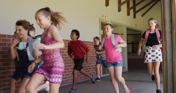 Group of kids running in the school corridor