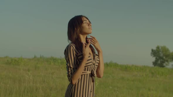 Portrait of Serene Lovely Black Female Inhaling Fresh Air in Summer Nature