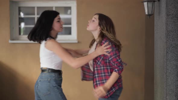 Two Aggressive Teenage Girls Fighting Outdoors Pushing Hitting Each Other