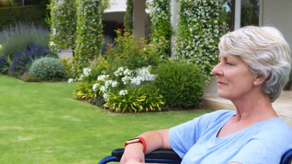 Thoughtful senior woman sitting in wheelchair