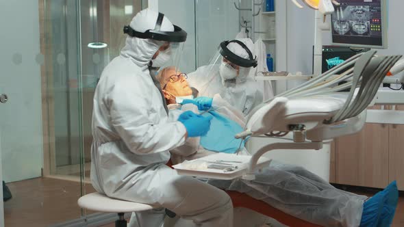 Dentist with Medical Overall Checking Patient Dental Problem