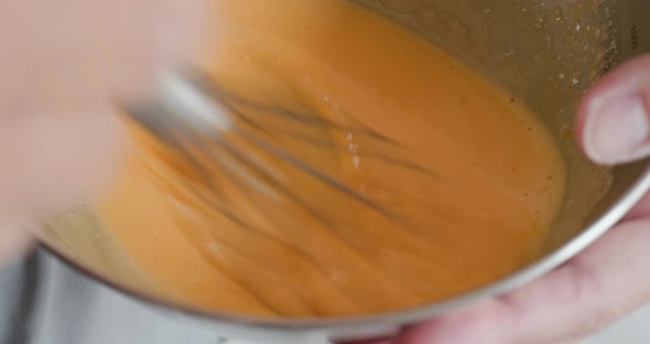 Stirring egg in the bowl 