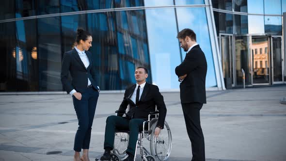 Cripple Businessman in Wheelchair and Two His Collegues Has Positive Conversation