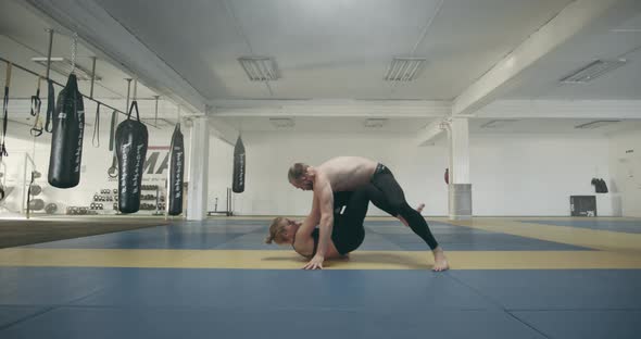 Woman And Man In Mixed Martial Arts Training
