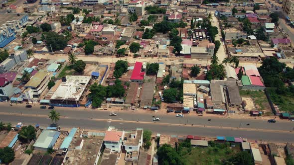 Cinematic Circular Motion Aerial View of African City traffic, showing water retention, Lomé, West A