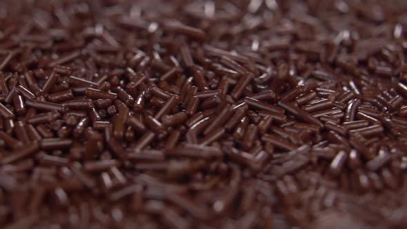 Dark chocolate sprinkles. Macro texture. Slow motion