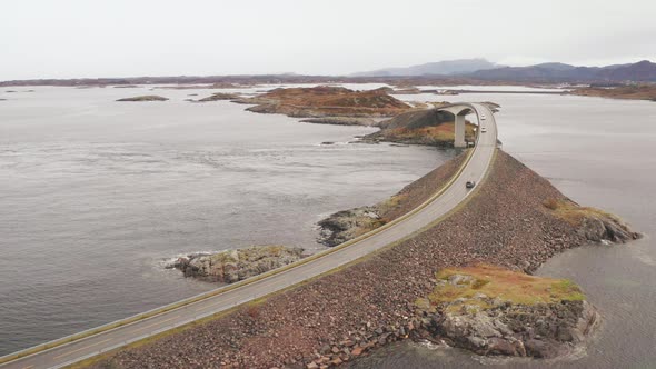 Aerial View Of Storseisundet Bridge in Atlantic Ocean Road With Cars Driving in Both Directions, Nor