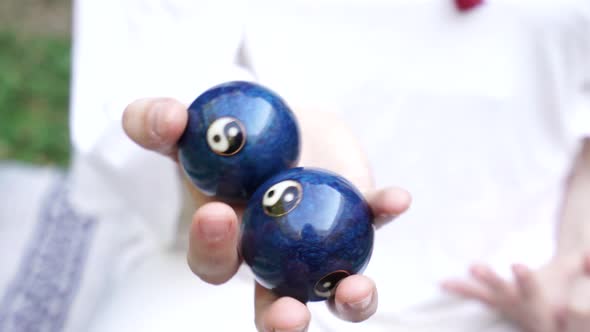 woman  with chinese balls used for meditation