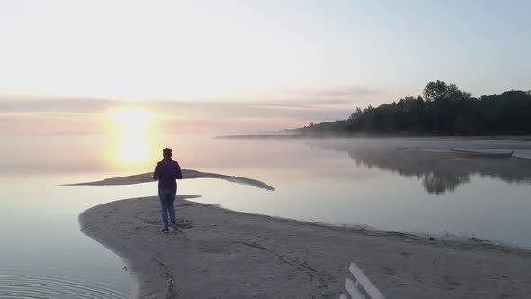 Woman Photographer on the Shores of Lake Svityaz Meets the Morning