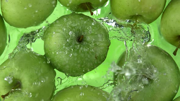 Super Slow Motion Shot of Fresh Green Apple Falling and Splashing Into Water at 1000Fps