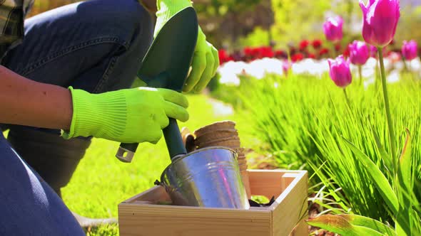 Happy Man with Tools in Box at Summer Garden