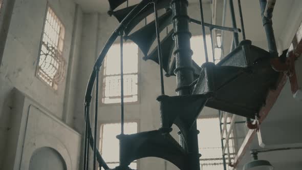 Rotating and tilt up shot of old greenish stairs at Alcatraz island Prison, USA